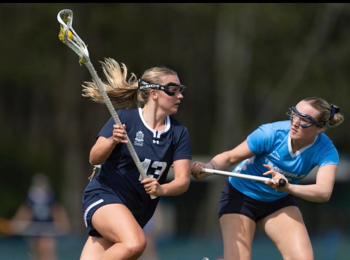 Stockport womens player drives round a hapless defender